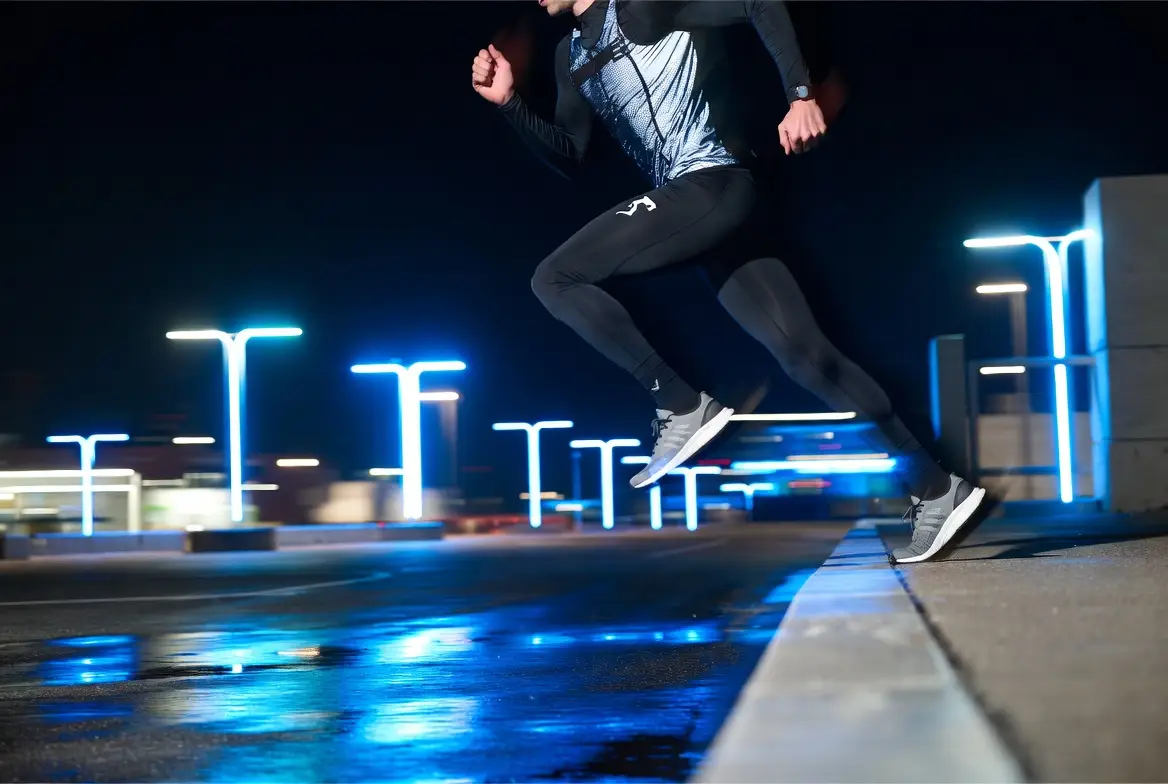 A night sports campaign frame with strong motion energy and dramatic city lighting.